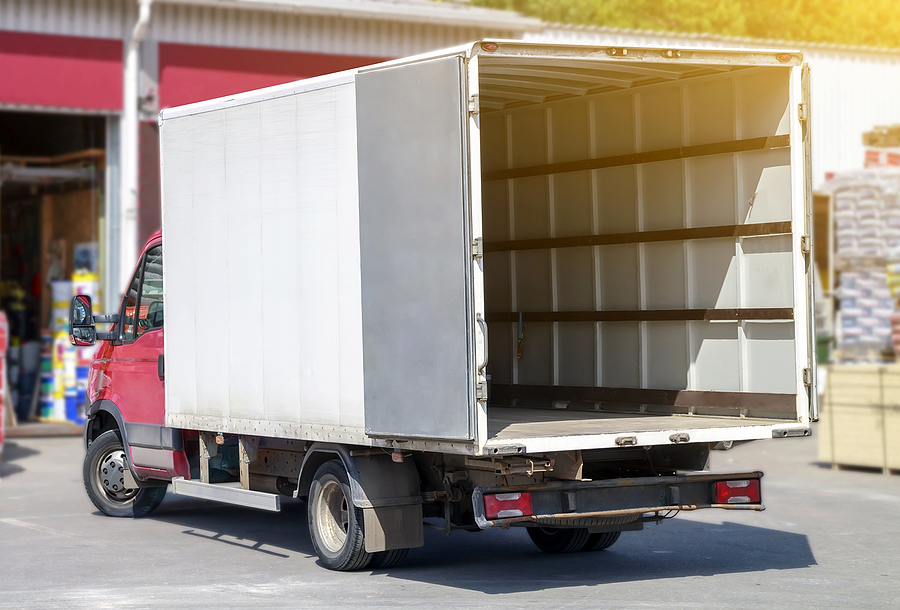 small truck with red cab stands with open empty body ready for loading cargo. lipping path is included